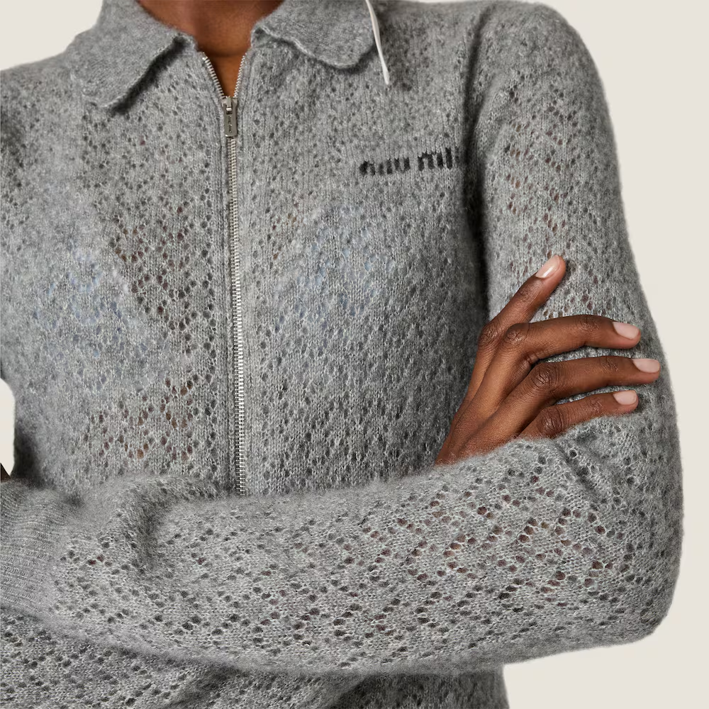 Grey knitwear worn by a person, showing the knitwear fit