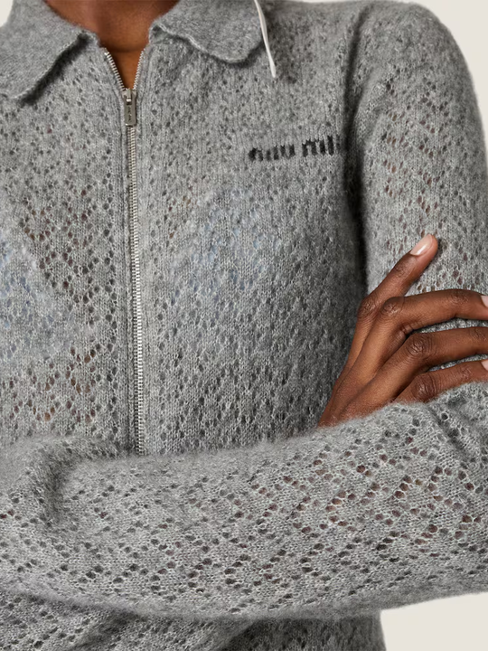 Grey knitwear worn by a person, showing the knitwear fit