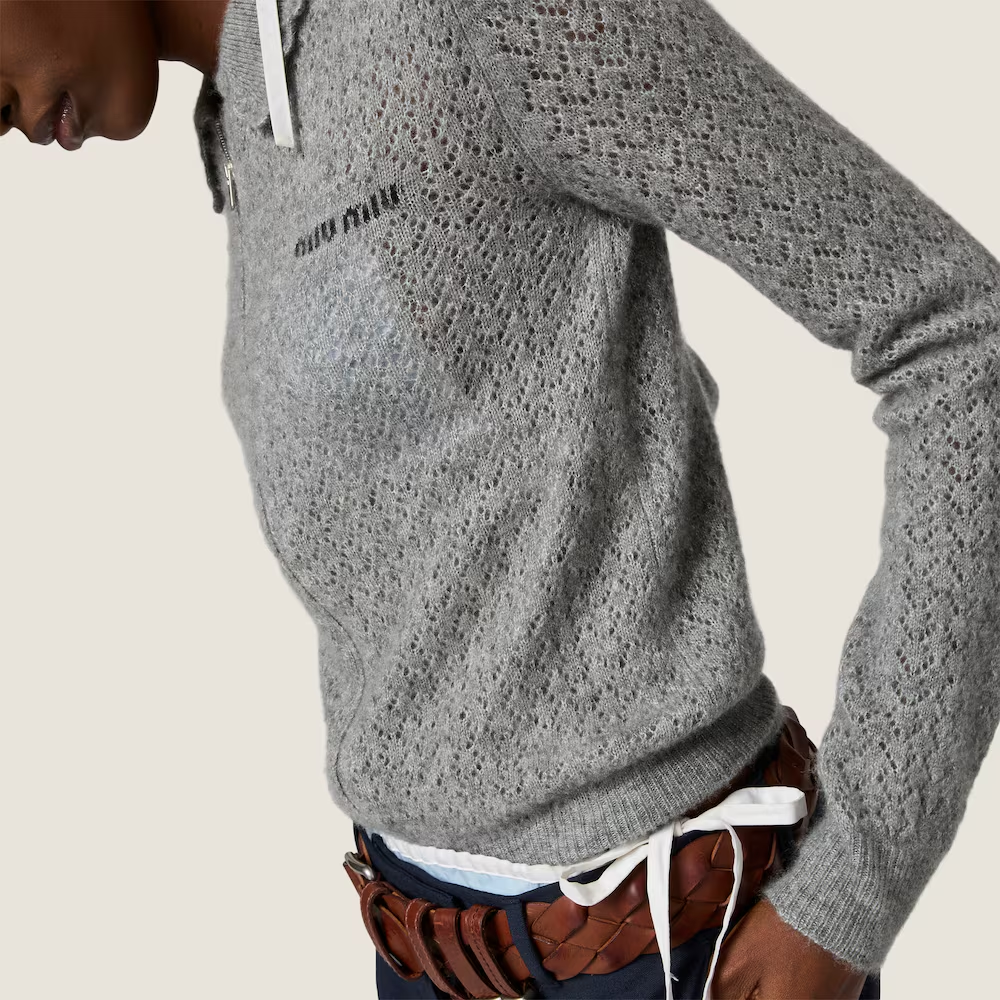 Grey knitwear worn by a person, showing the knitwear fit