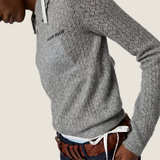 Grey knitwear worn by a person, showing the knitwear fit