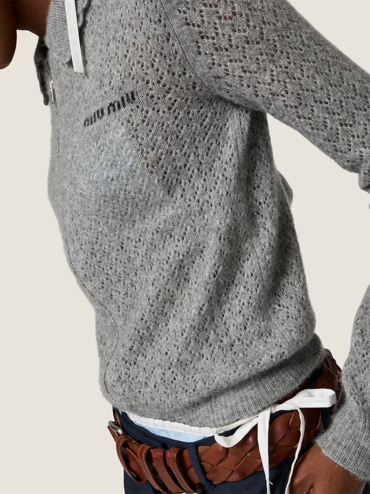 Grey knitwear worn by a person, showing the knitwear fit