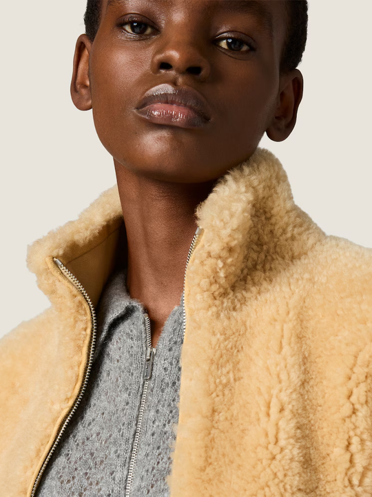 Grey knitwear worn by a person, showing the knitwear fit