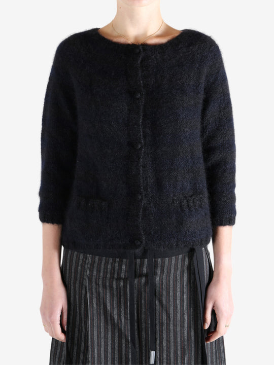 Black cardigan worn by a person, showing the cardigan's fit