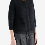 Black cardigan worn by a person, showing the cardigan's fit