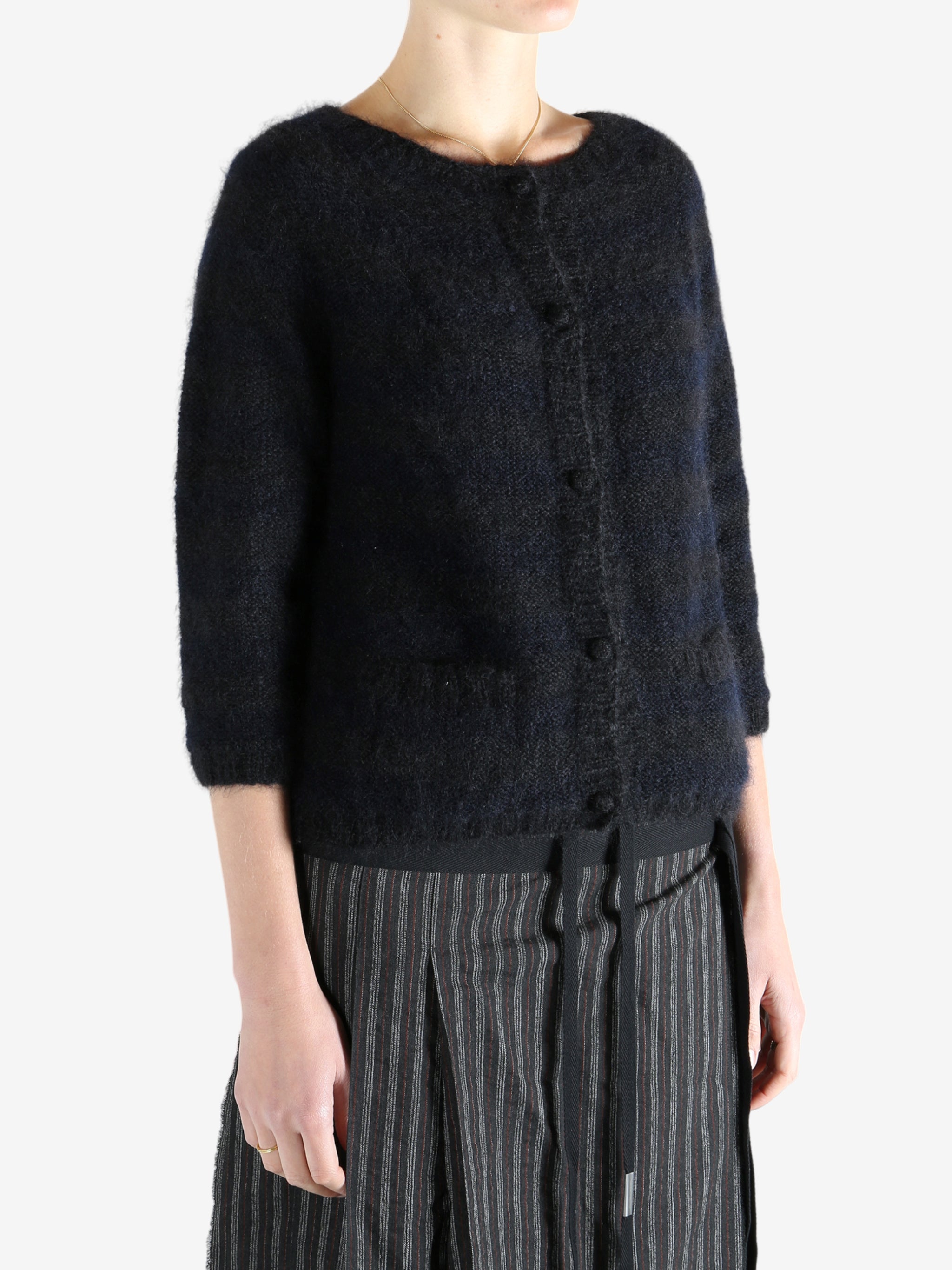 Black cardigan worn by a person, showing the cardigan's fit