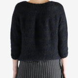 Black cardigan worn by a person, showing the cardigan's fit