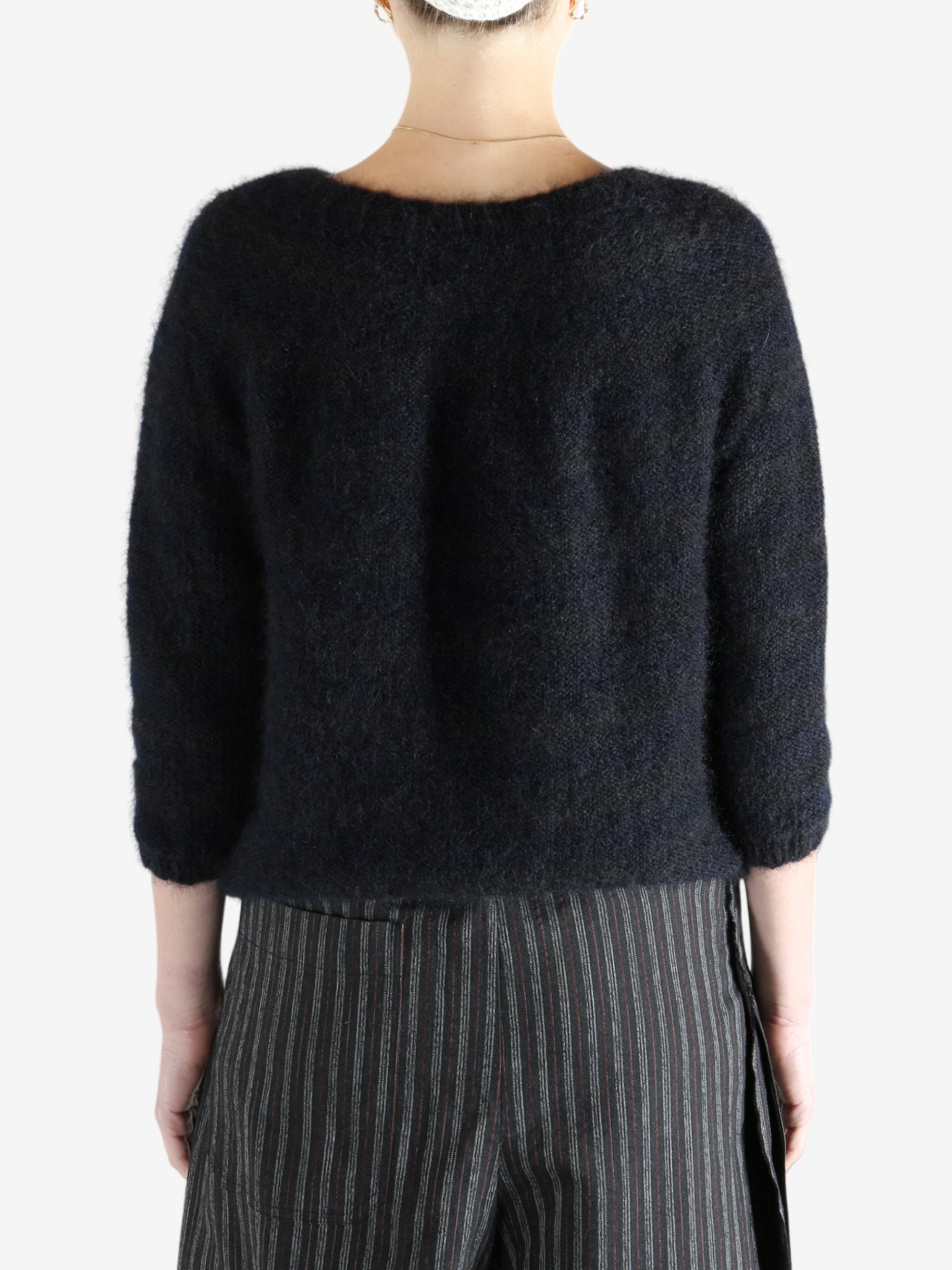 Black cardigan worn by a person, showing the cardigan's fit