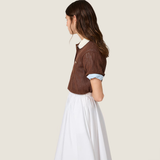 Brown shirt worn by a person, showing the shirt fit