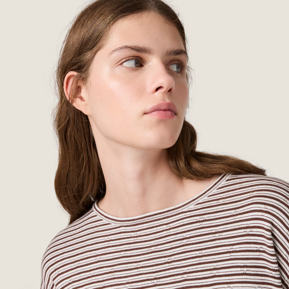 Brown knitwear worn by a person, showing the knitwear fit