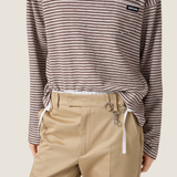 Brown knitwear worn by a person, showing the knitwear fit