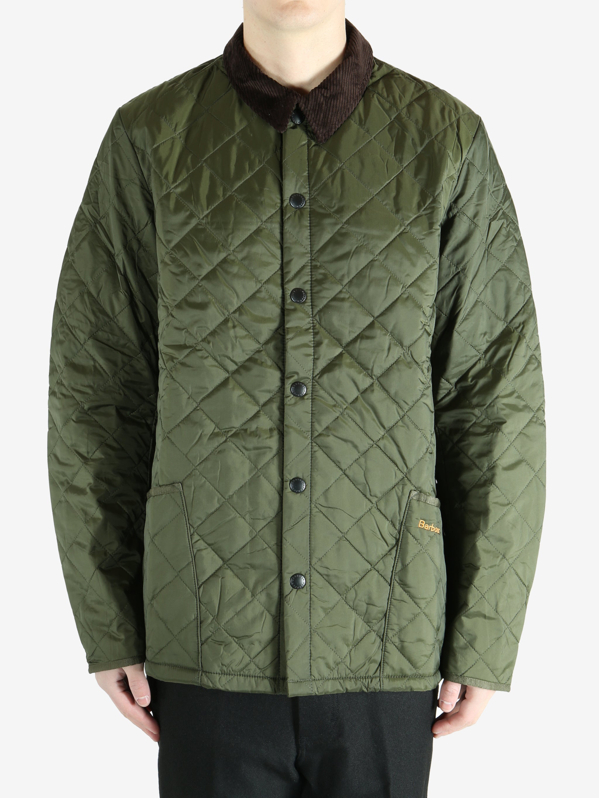 Green jacket worn by a person, showing the  jacket fit