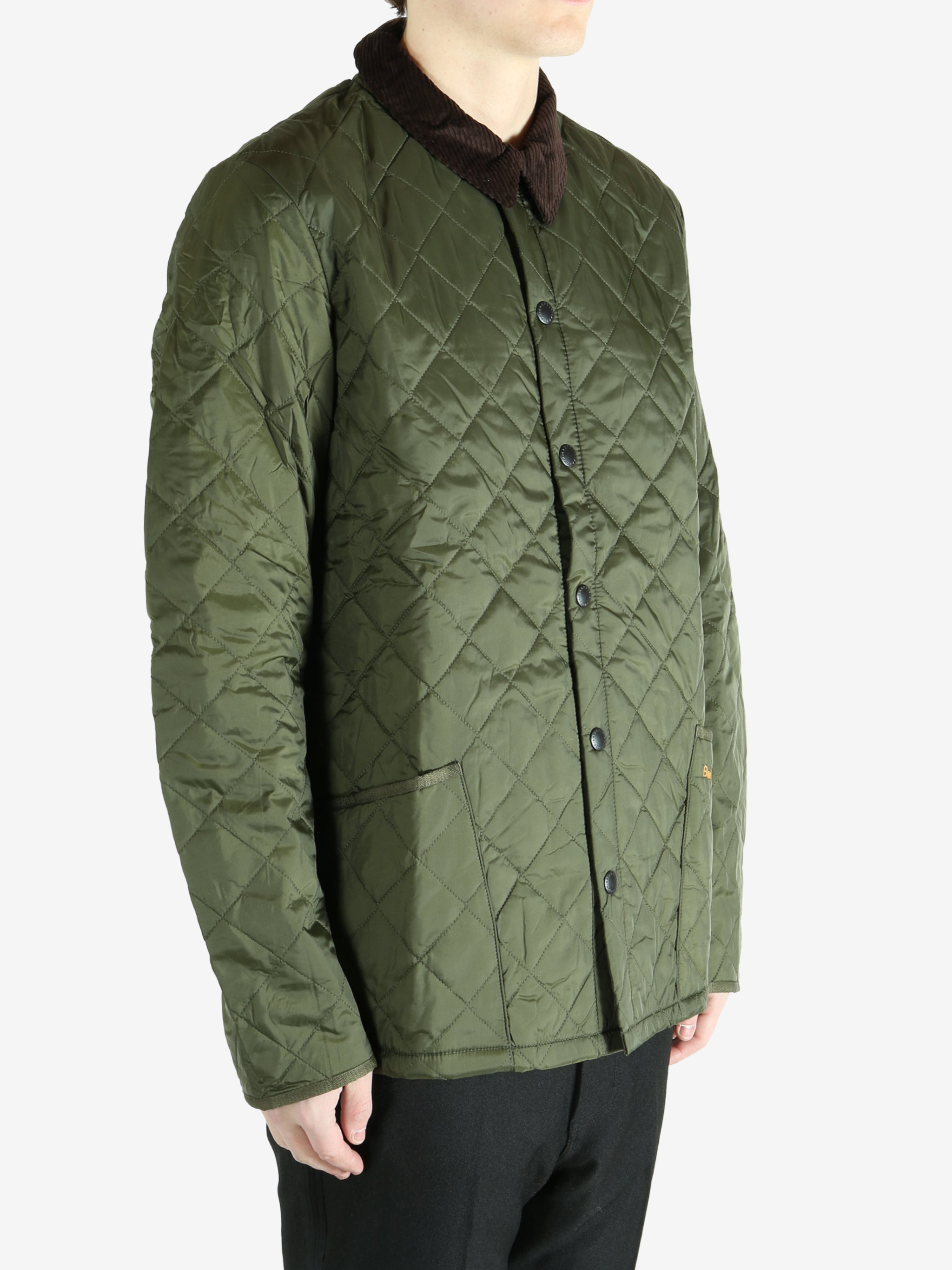 Green jacket worn by a person, showing the  jacket fit