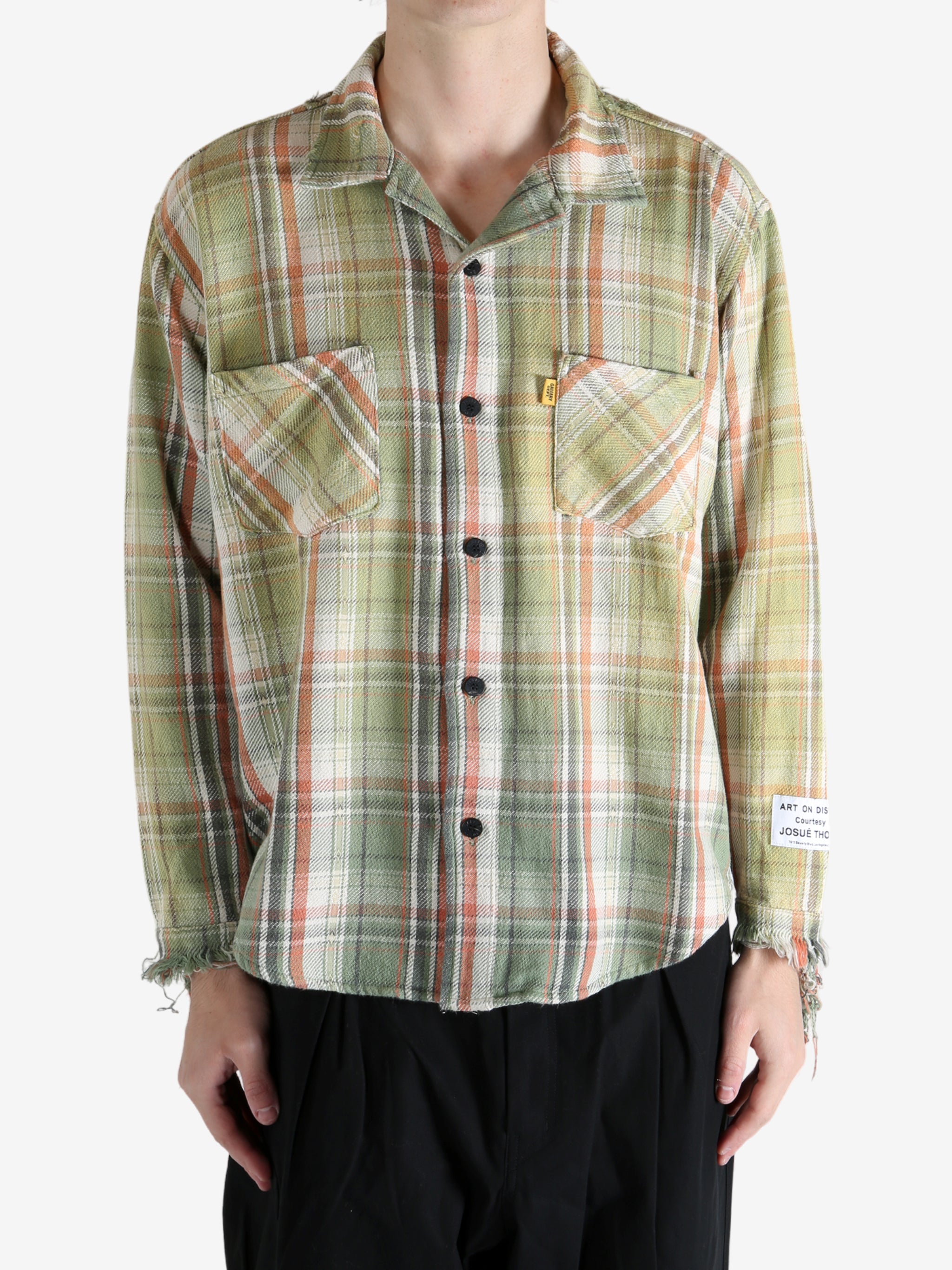 Green shirts worn by a person, showing the shirts's fit