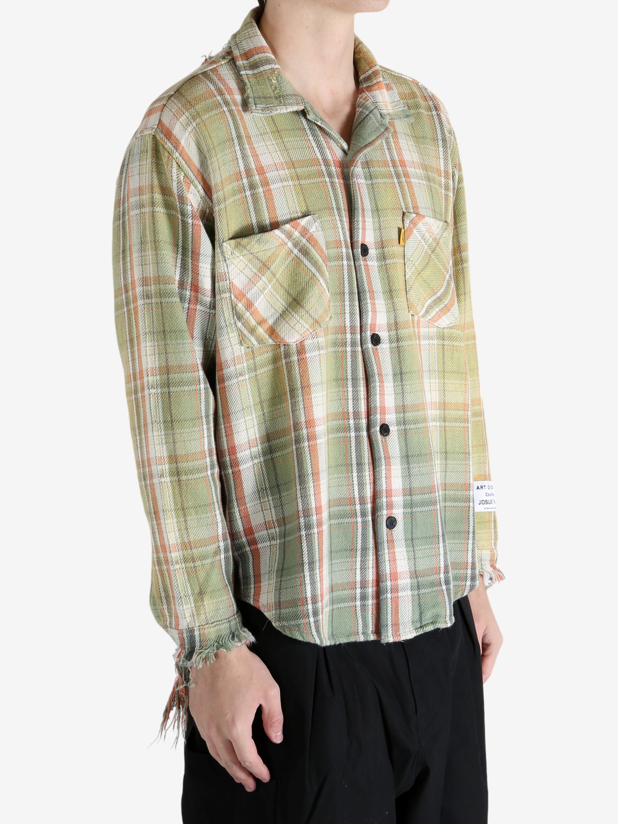 Green shirts worn by a person, showing the shirts's fit