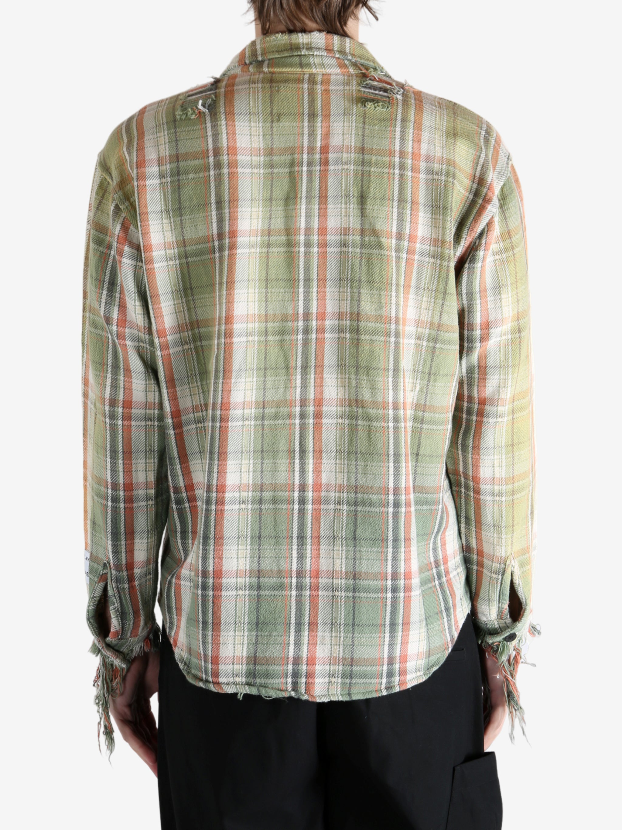 Green shirts worn by a person, showing the shirts's fit