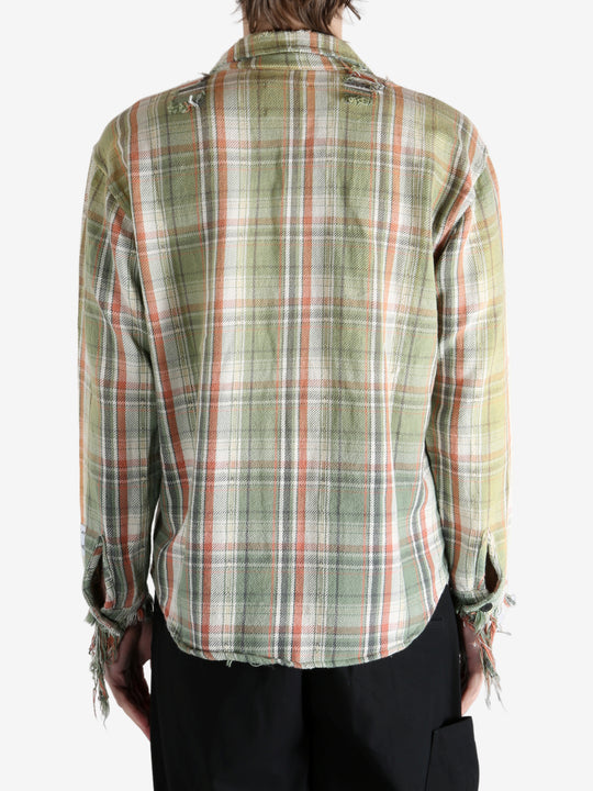 Green shirts worn by a person, showing the shirts's fit