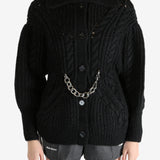 Black knitwear worn by a person, showing the knitwear fit