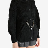 Black knitwear worn by a person, showing the knitwear fit
