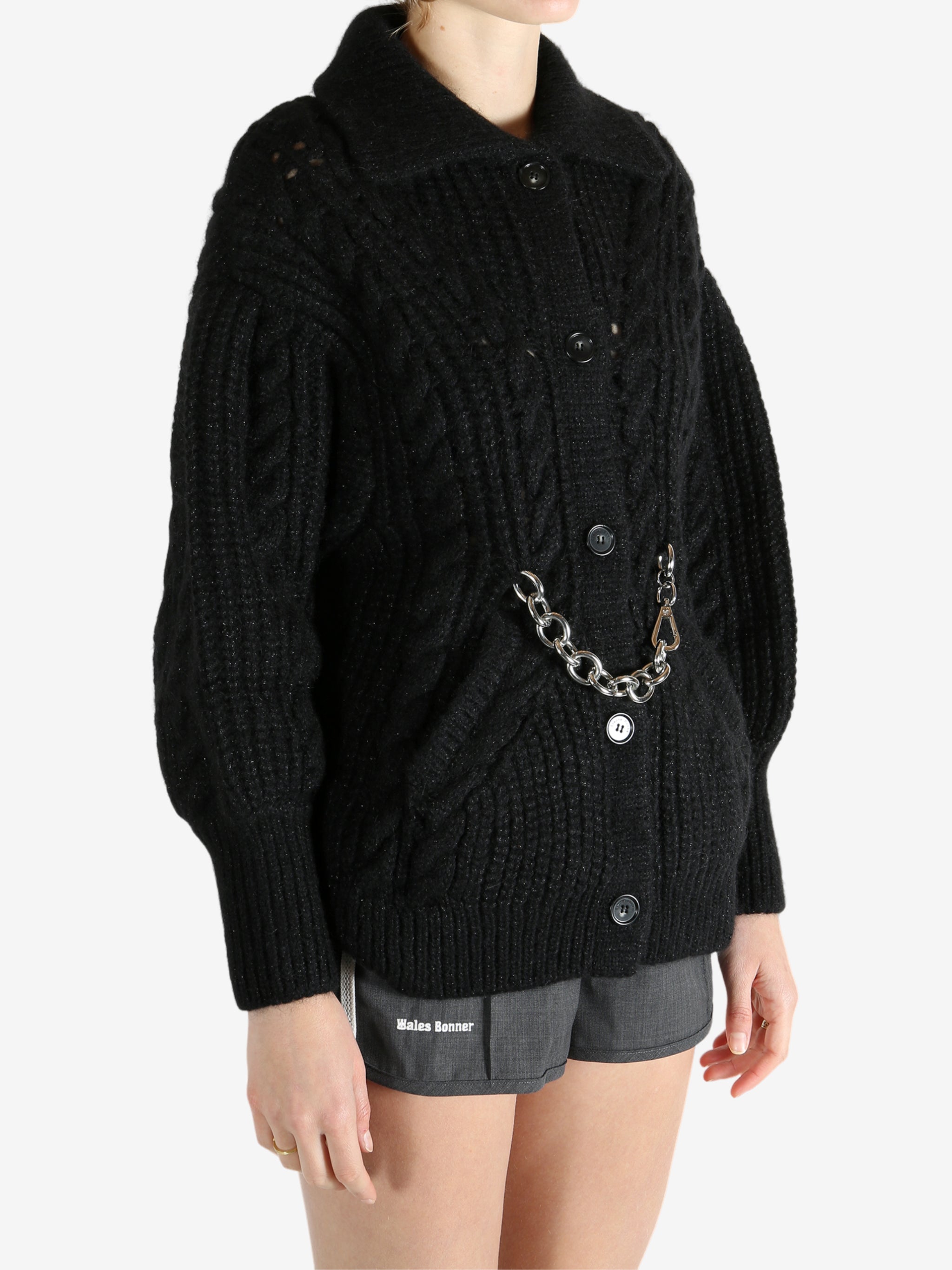 Black knitwear worn by a person, showing the knitwear fit