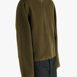 Brown sweater worn by a person, showing the sweater fit