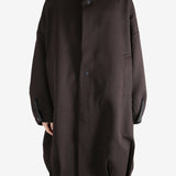 Brown jacket worn by a person, showing the jacket's fit