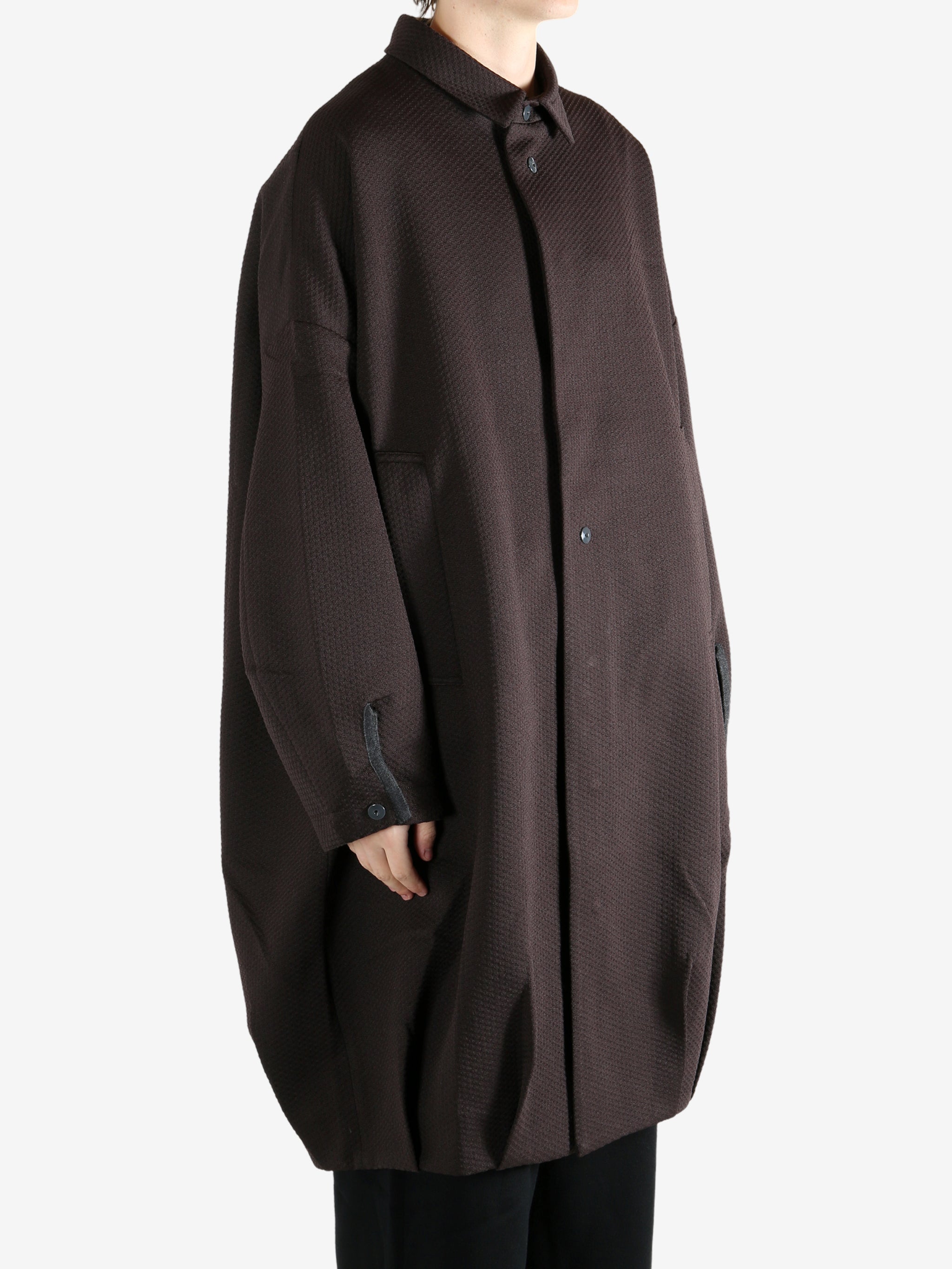 Brown jacket worn by a person, showing the jacket's fit