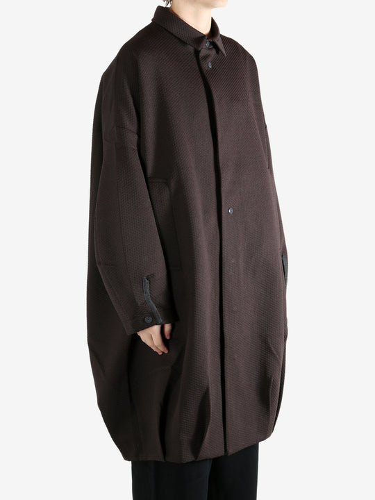 Brown jacket worn by a person, showing the jacket's fit