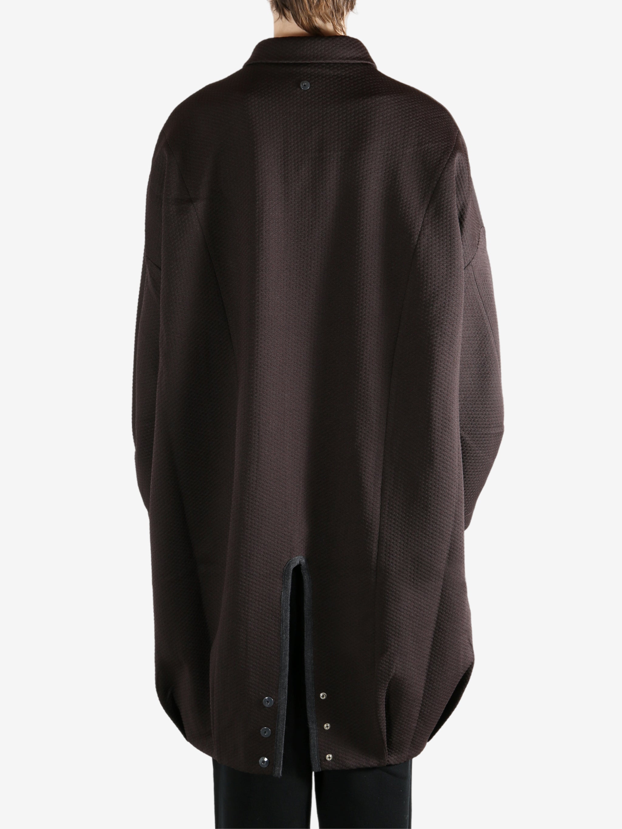 Brown jacket worn by a person, showing the jacket's fit