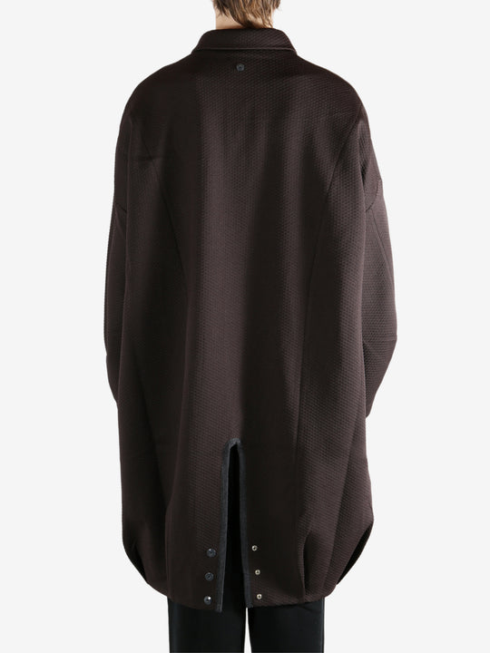 Brown jacket worn by a person, showing the jacket's fit