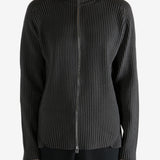 Black knitwear worn by a person, showing the knitwear's fit