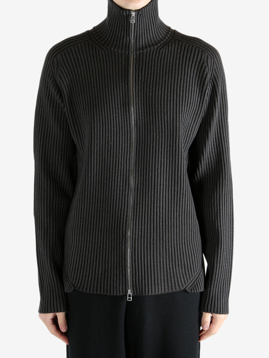 Black knitwear worn by a person, showing the knitwear's fit