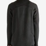 Black knitwear worn by a person, showing the knitwear's fit