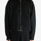 Black knitwear worn by a person, showing the knitwear's fit