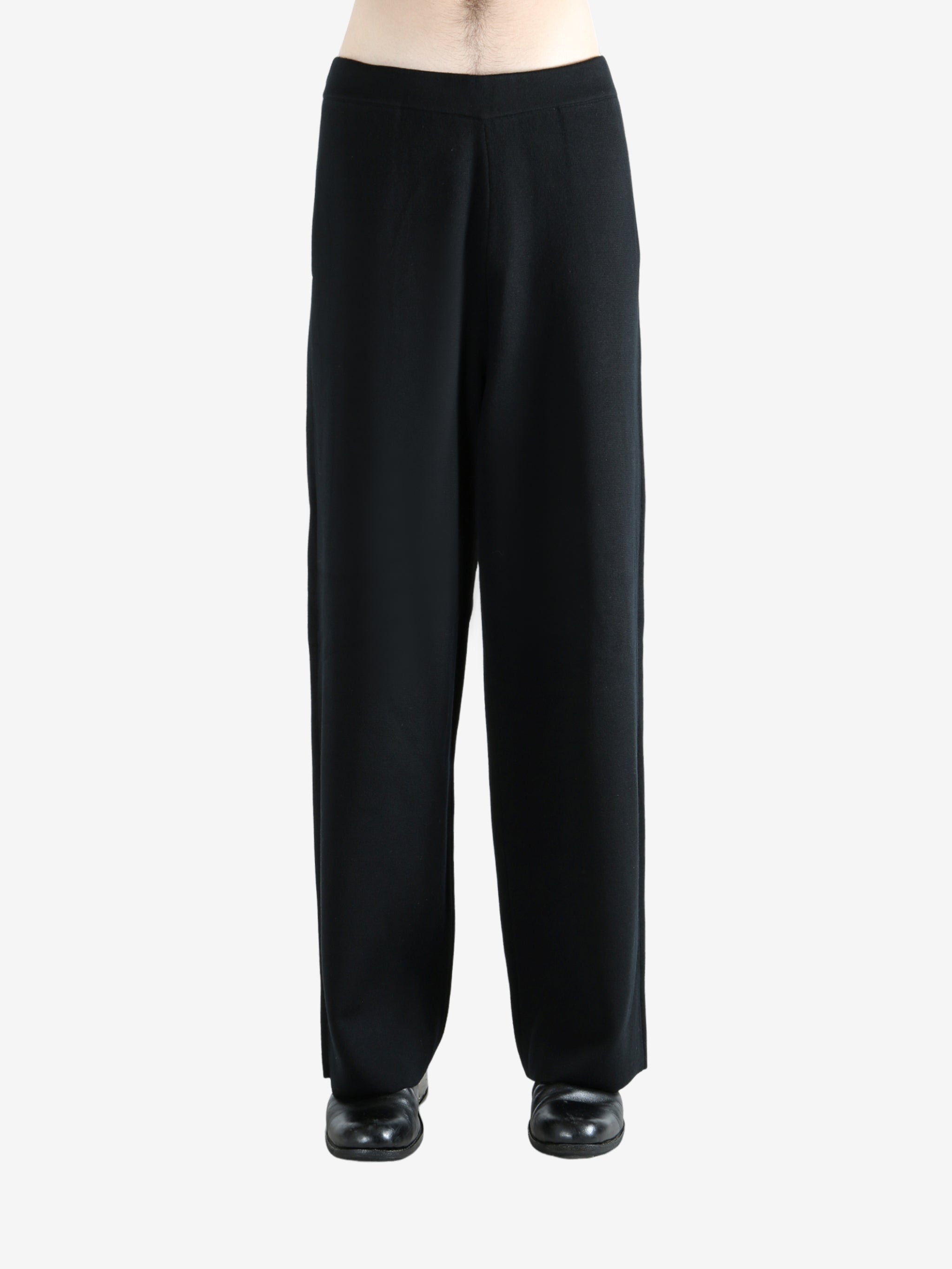 Black pants worn by a person, showing the pants's fit