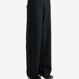 Black pants worn by a person, showing the pants's fit