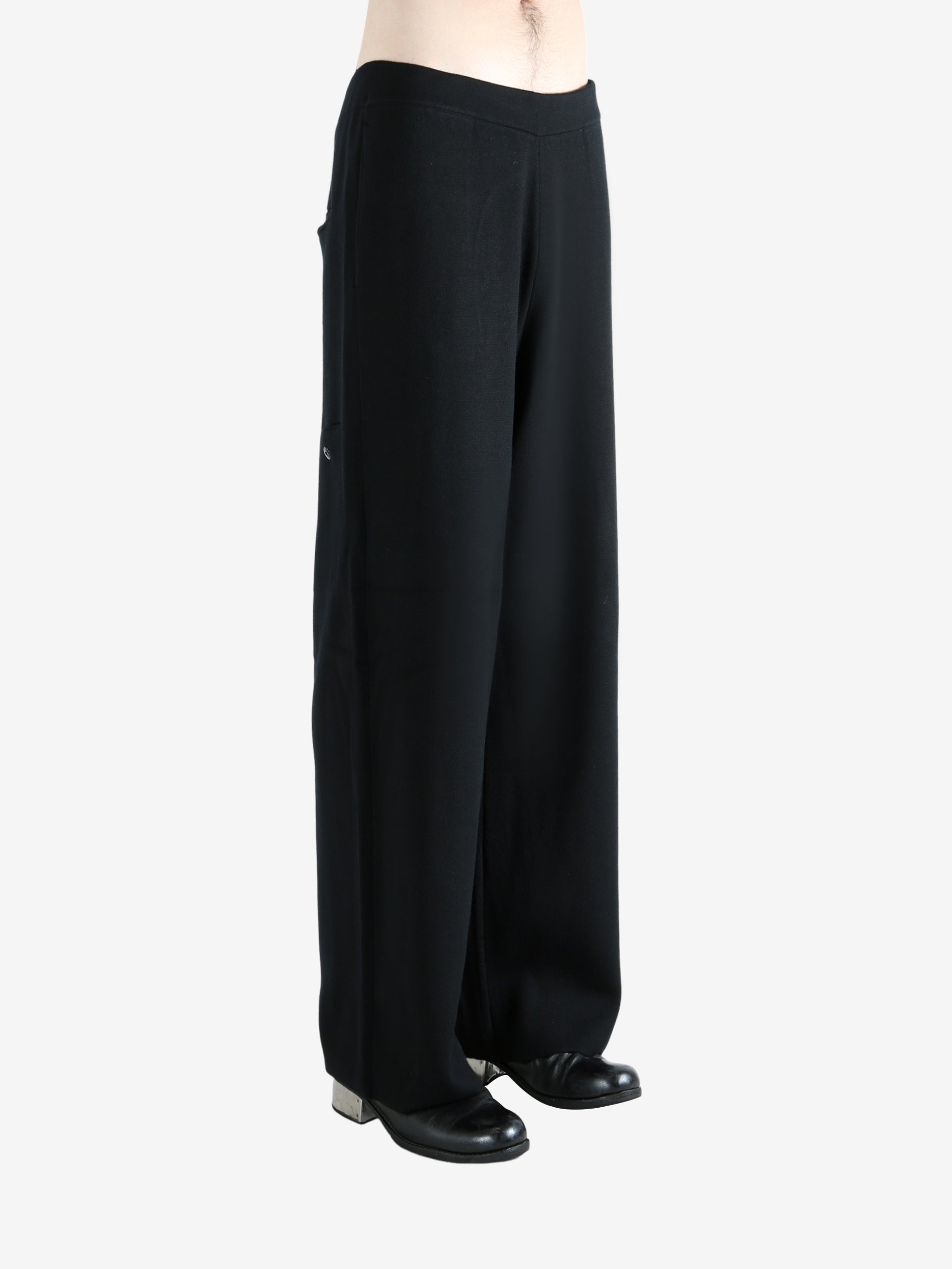 Black pants worn by a person, showing the pants's fit