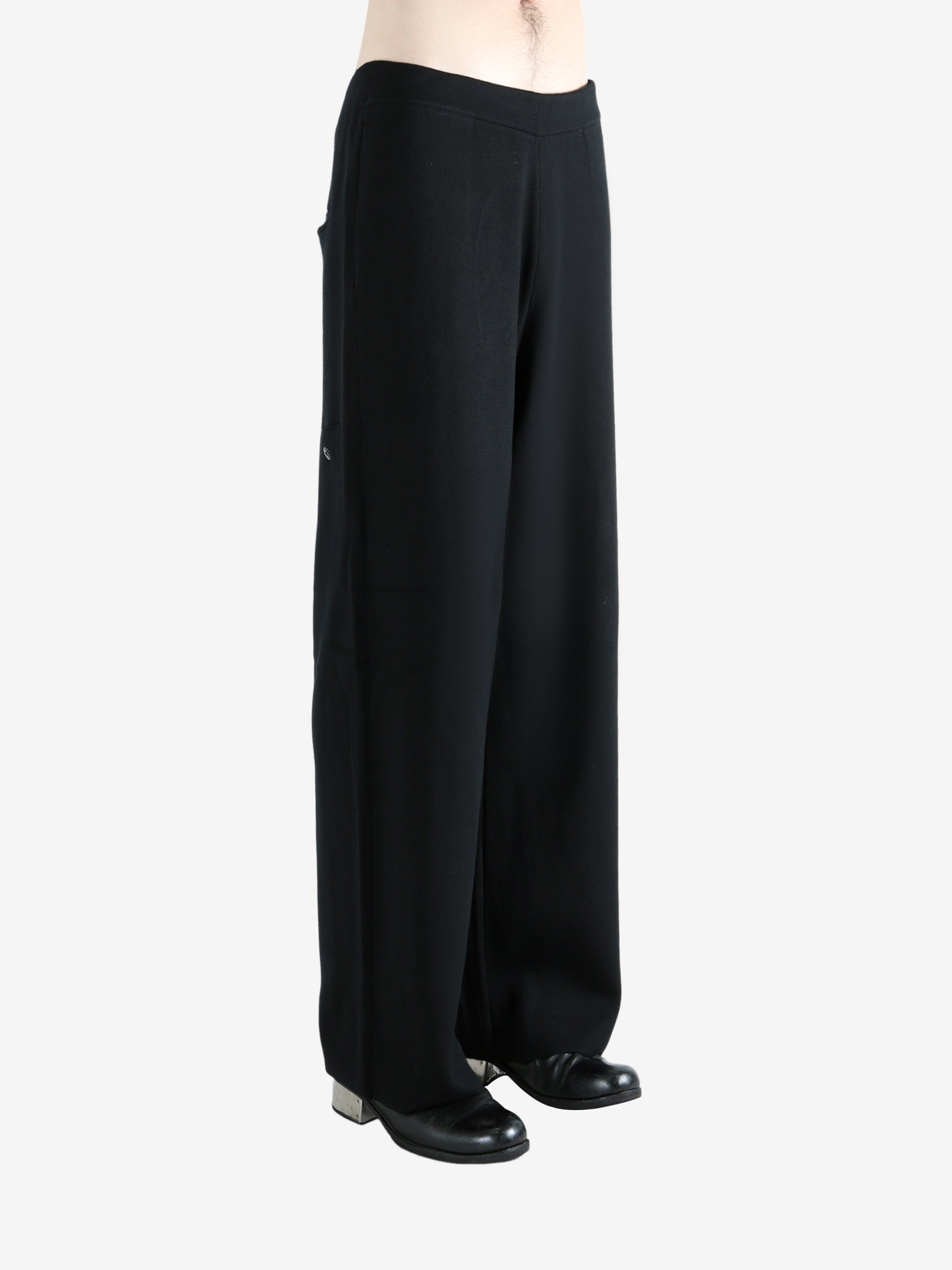 Black pants worn by a person, showing the pants's fit