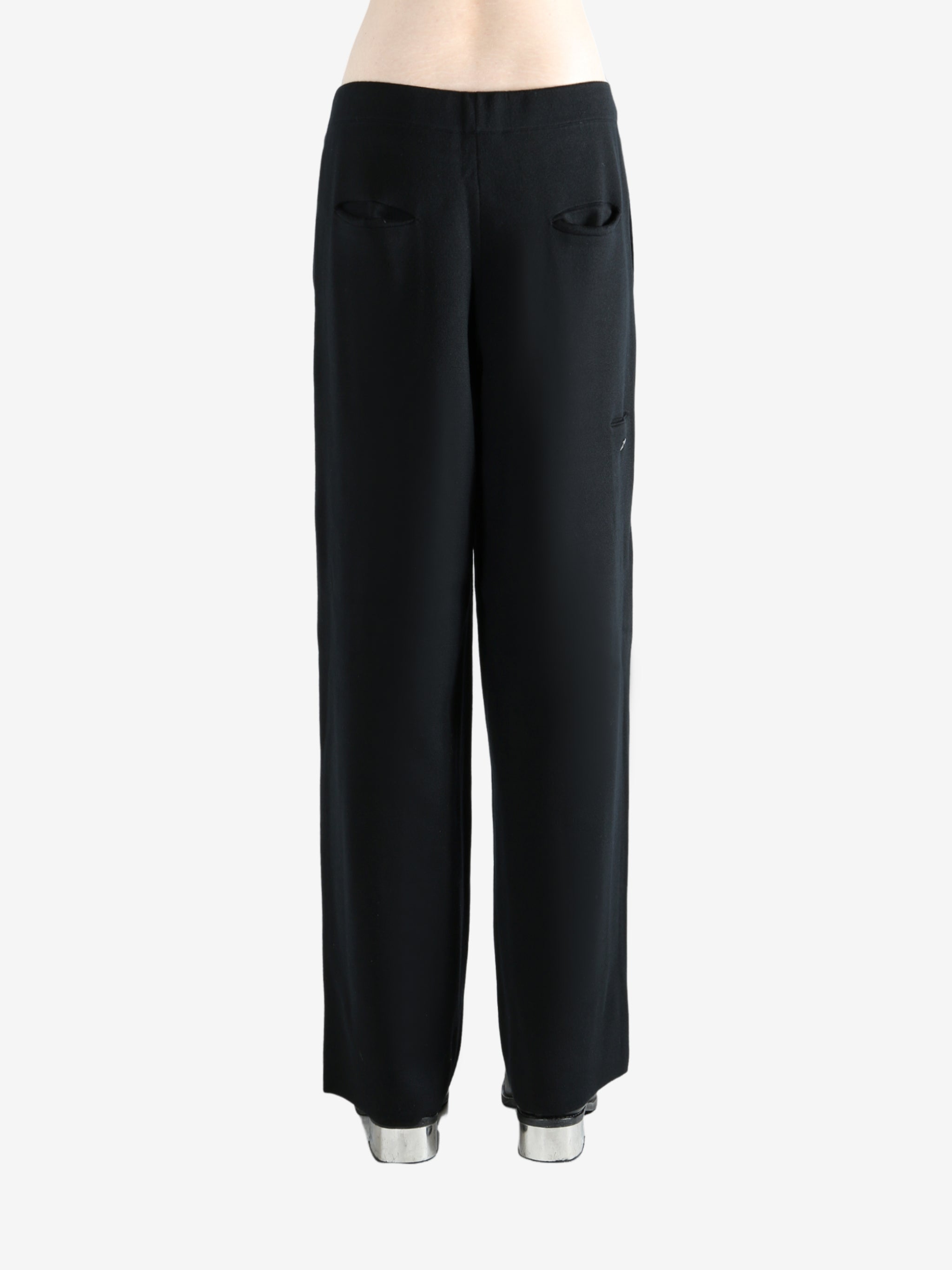 Black pants worn by a person, showing the pants's fit