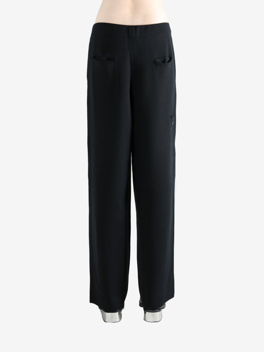 Black pants worn by a person, showing the pants's fit