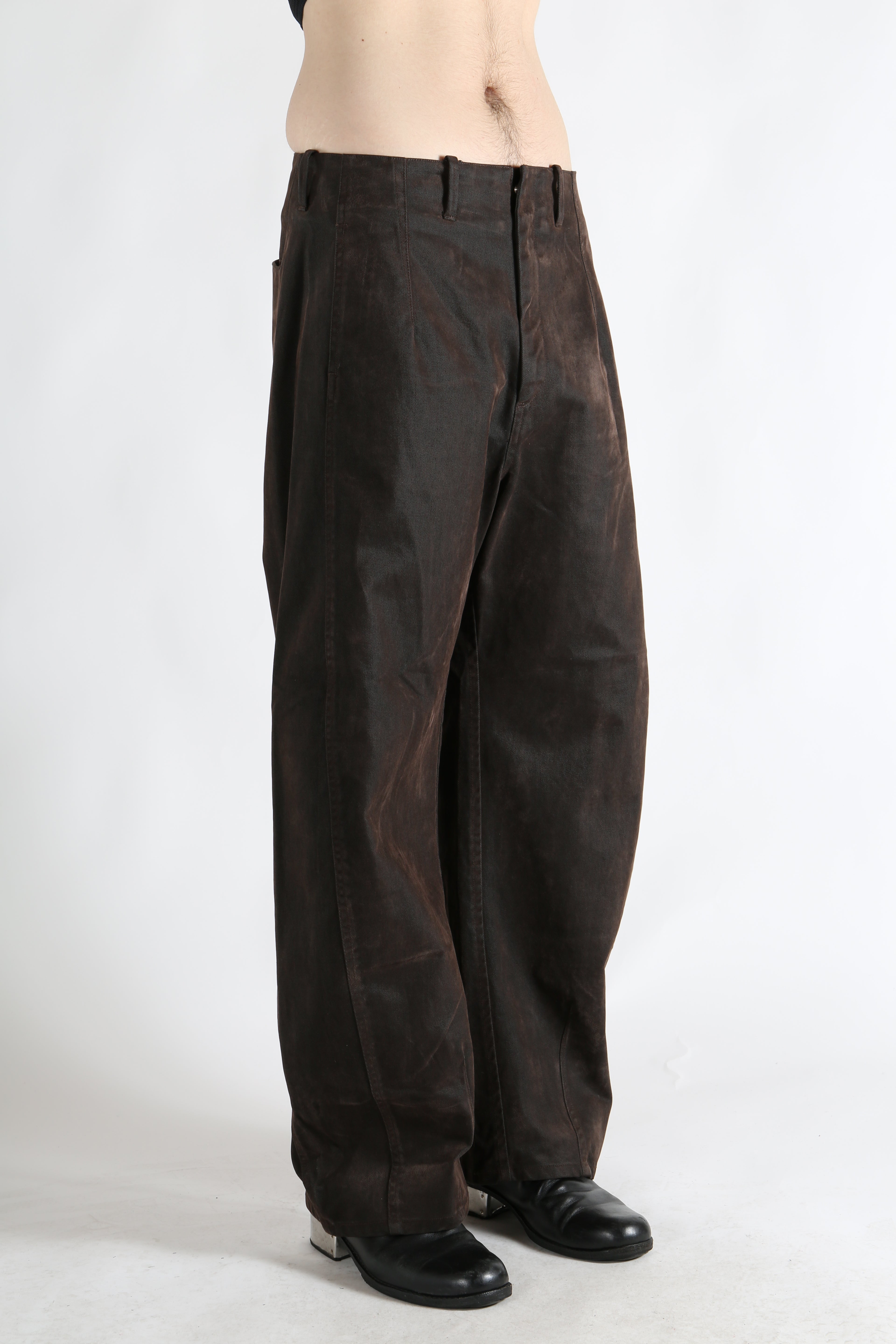 Brown pants worn by a person, showing the pants fit