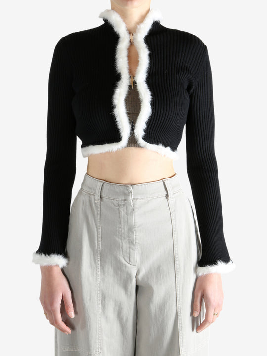 Black jacket worn by a person, showing the jecket's fit