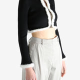 Black jacket worn by a person, showing the jecket's fit