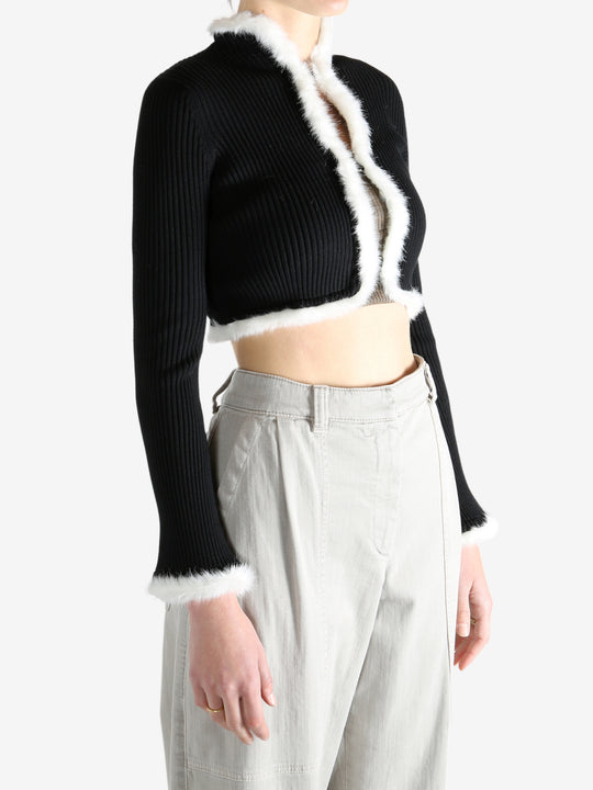 Black jacket worn by a person, showing the jecket's fit