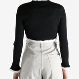 Black jacket worn by a person, showing the jecket's fit