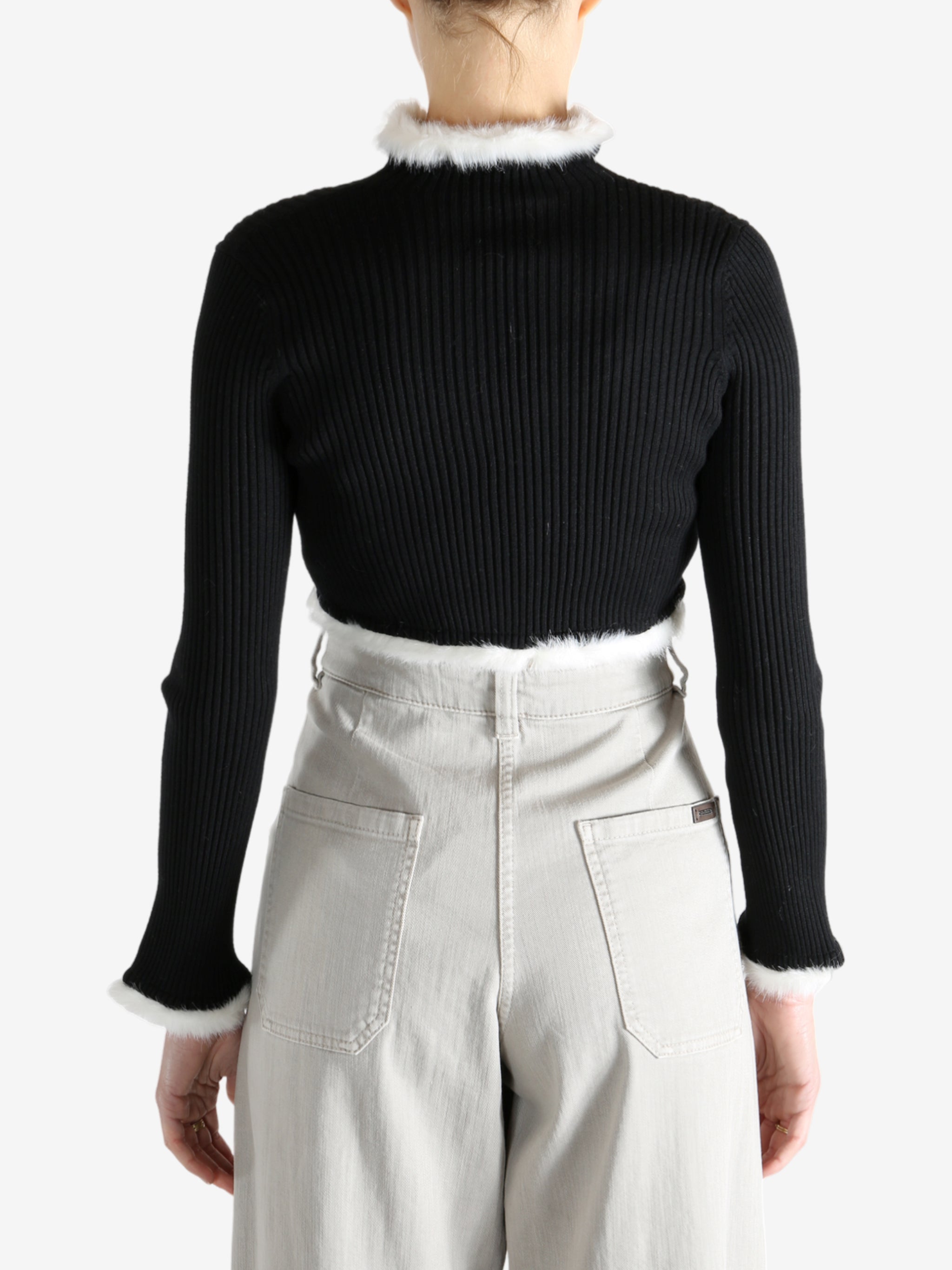 Black jacket worn by a person, showing the jecket's fit