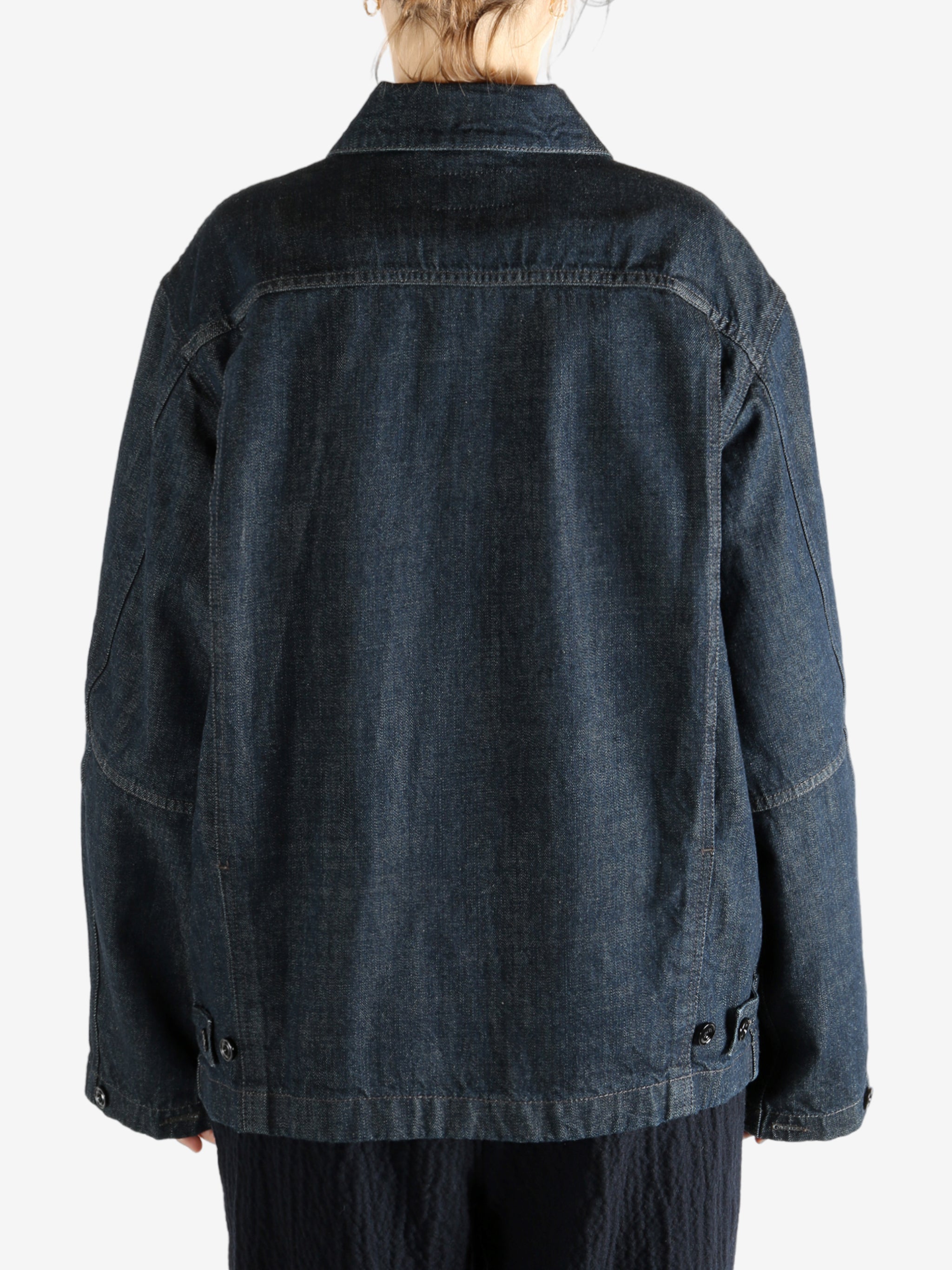 Blue jacket worn by a person, showing the jacket fit