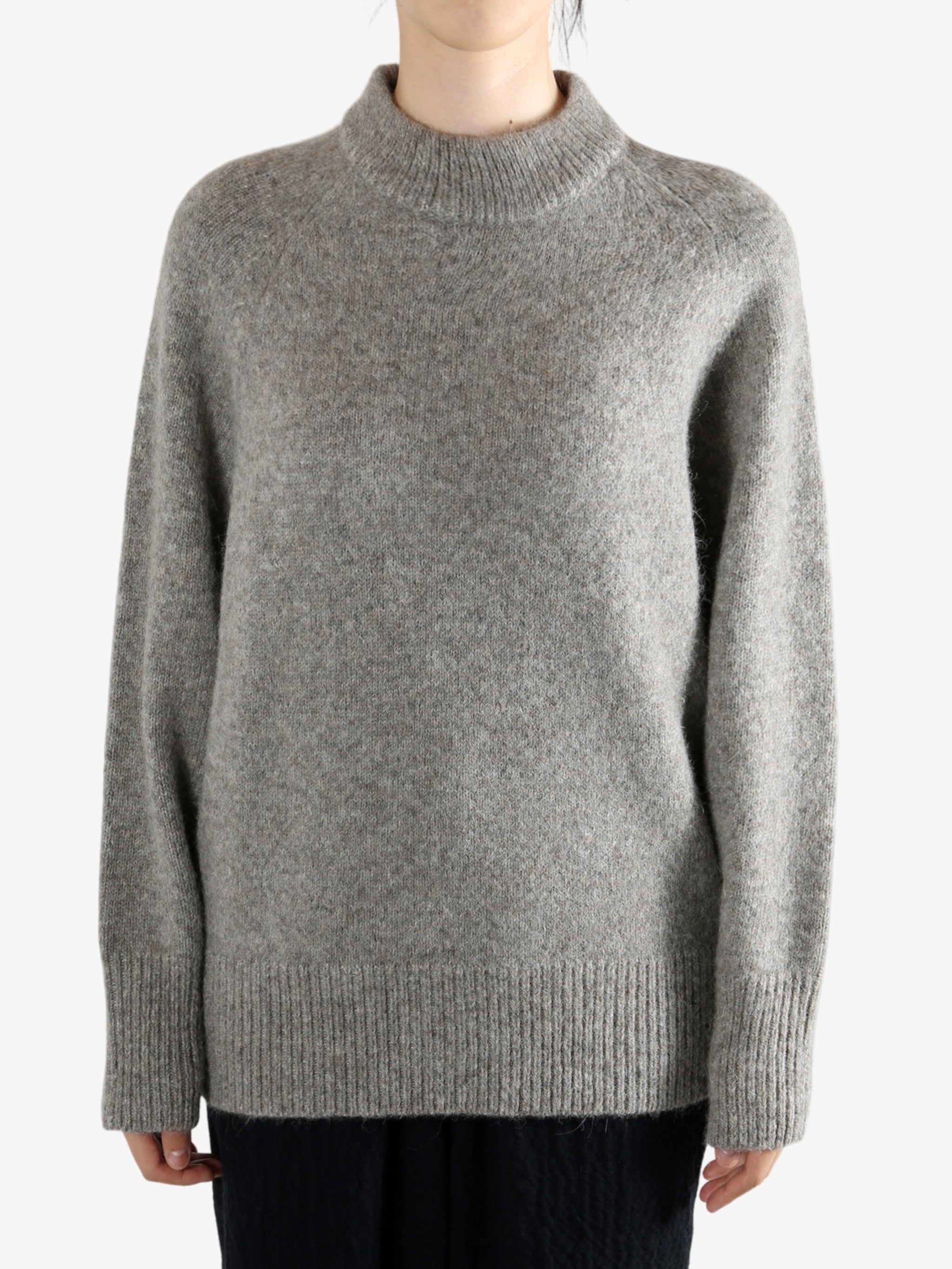 Grey sweater worn by a person, showing the sweater fit