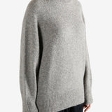 Grey sweater worn by a person, showing the sweater fit