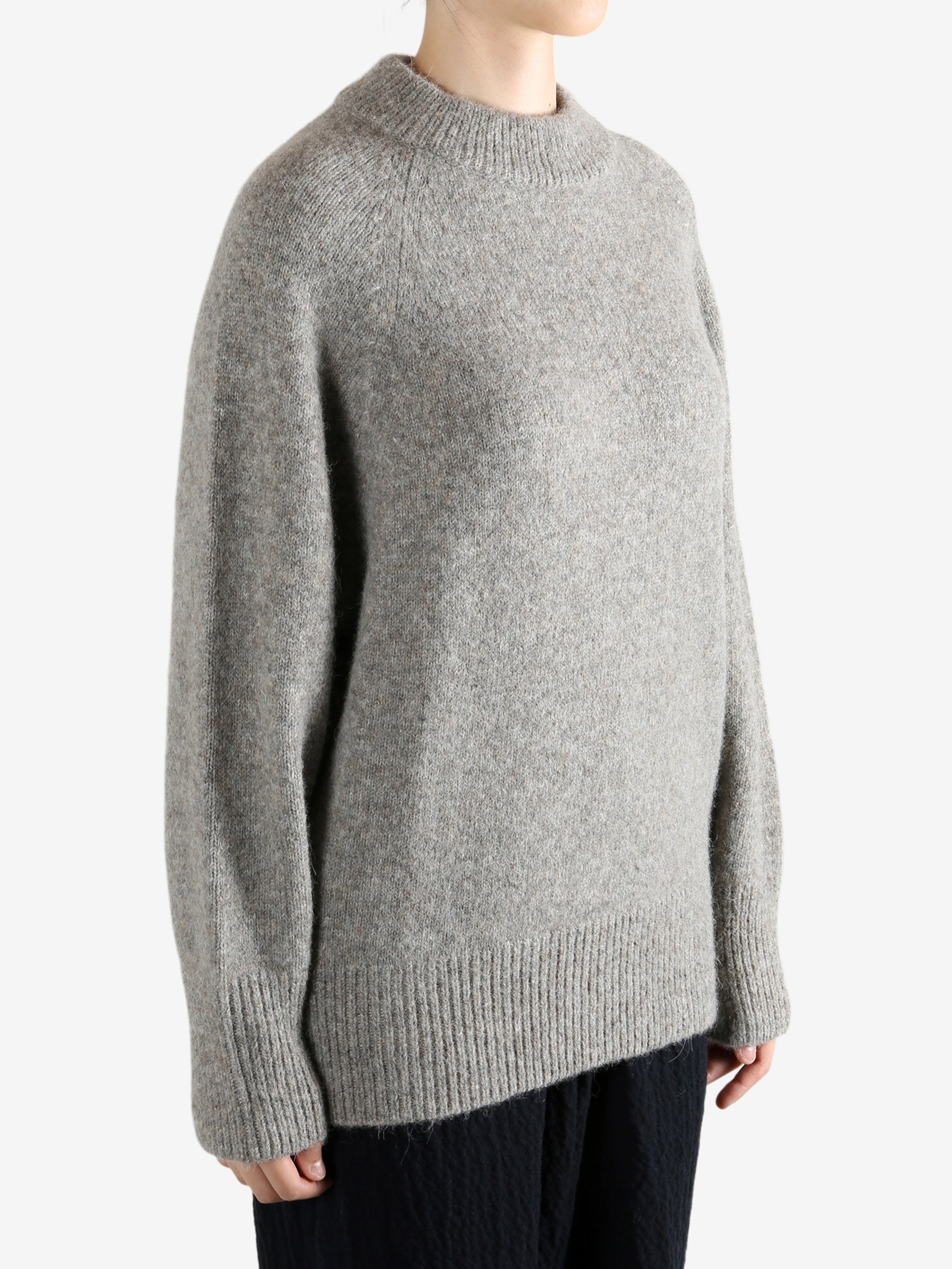 Grey sweater worn by a person, showing the sweater fit
