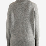 Grey sweater worn by a person, showing the sweater fit